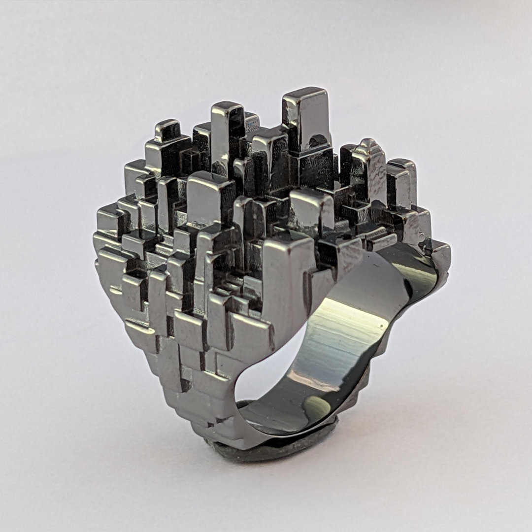 bague Ville Megapolis, en platine noir, posée verticalement sur un fond blanc. Eclairage de studio